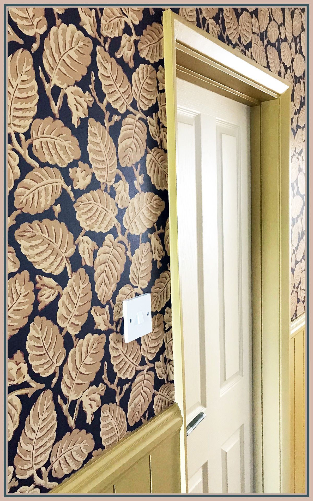 Leaf-pattern wallpaper expertly aligned across an interior wall